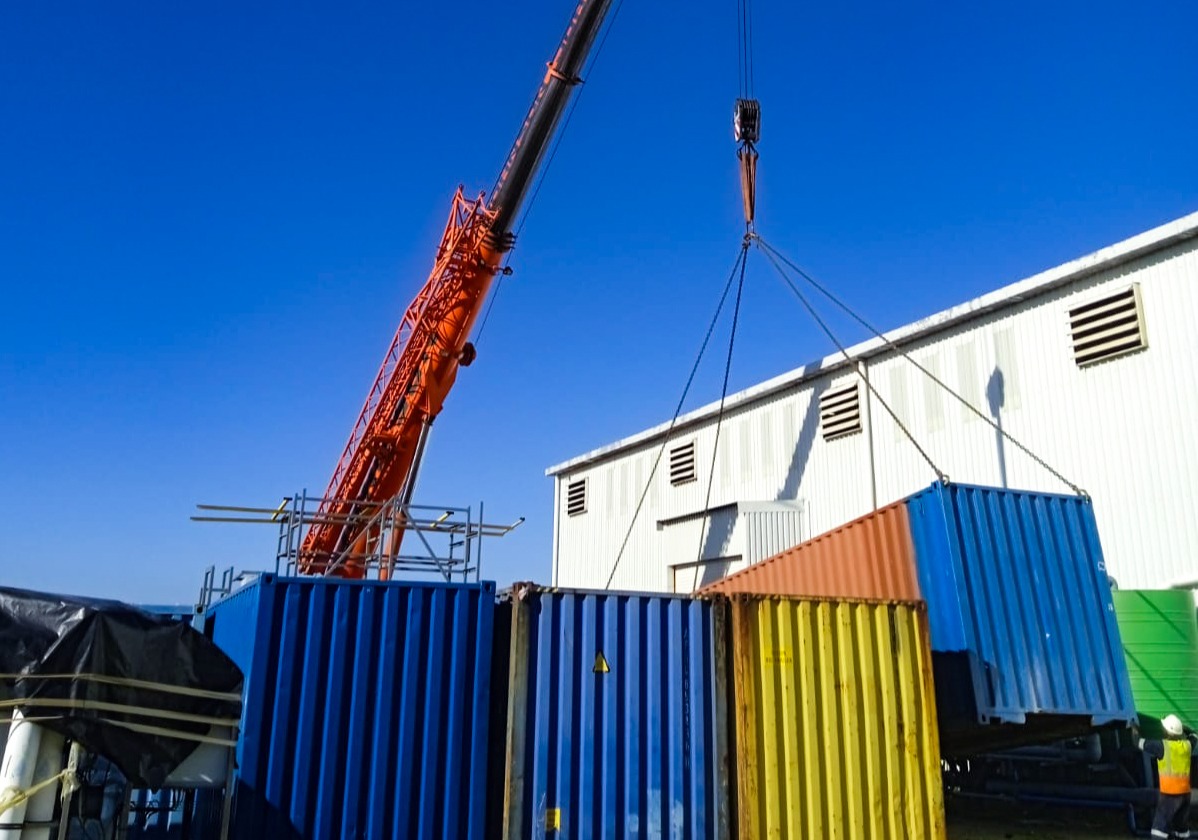 Container being moved by mobile crane